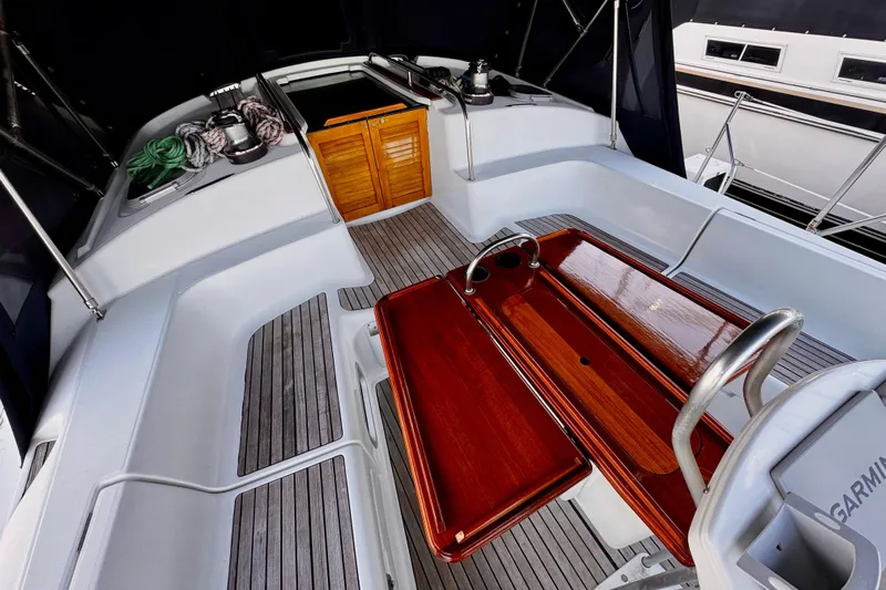  Yacht Photos Pics Jeanneau Sun Odyssey 43 DS 2001 cockpit with wooden table and seating area.