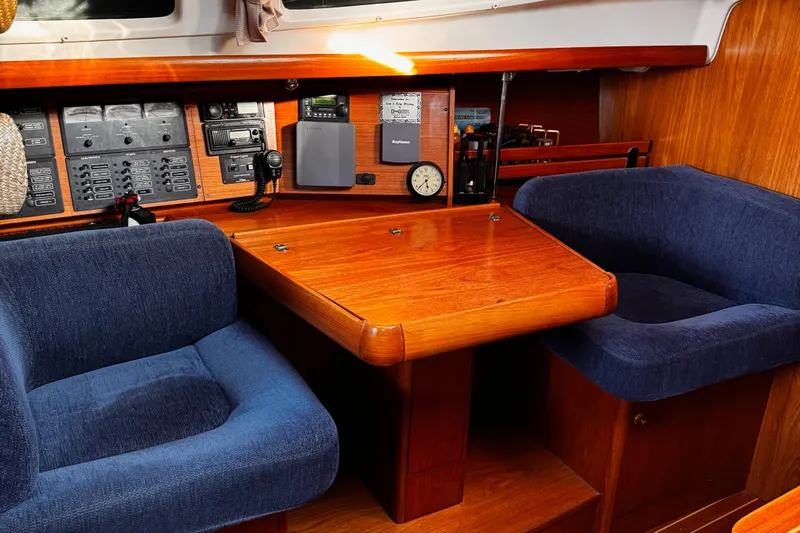  Yacht Photos Pics Cozy interior of 2001 Jeanneau Sun Odyssey 43 DS sailboat with navigation equipment.