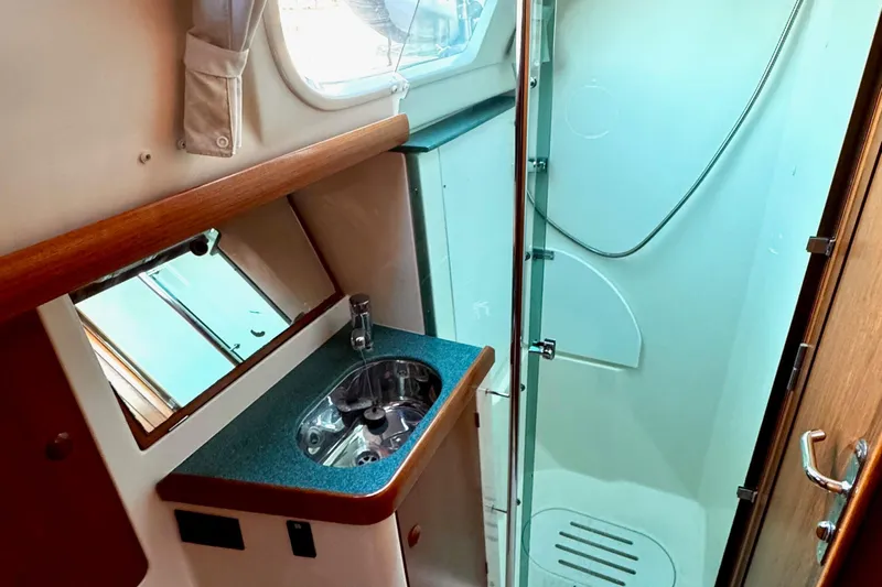  Yacht Photos Pics Interior of 2001 Jeanneau Sun Odyssey 43 DS yacht bathroom with sink and shower.