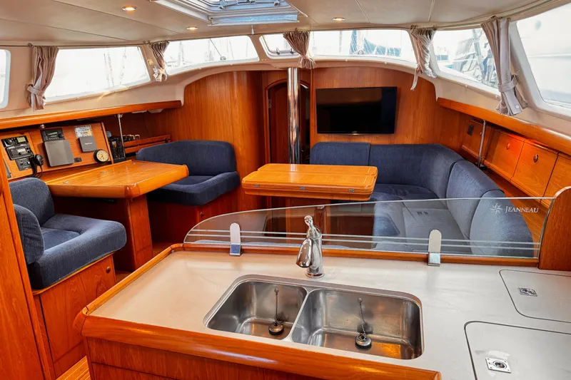  Yacht Photos Pics Interior of 2001 Jeanneau Sun Odyssey 43 DS yacht with cozy seating and modern amenities.