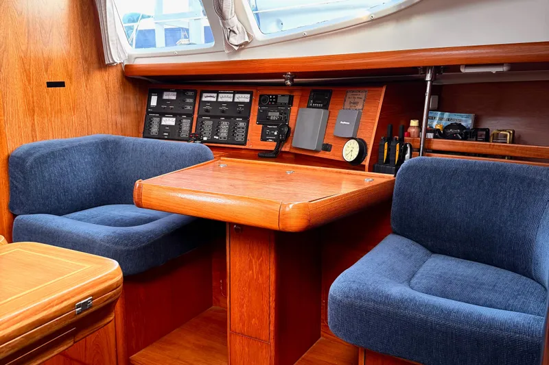  Yacht Photos Pics Interior of 2001 Jeanneau Sun Odyssey 43 DS yacht with navigation panel and seating.