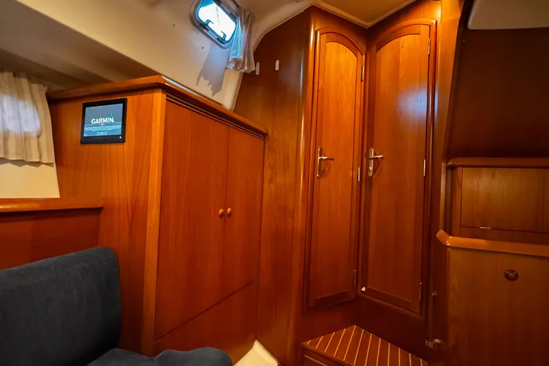  Yacht Photos Pics Interior of 2001 Jeanneau Sun Odyssey 43 DS yacht with wooden cabinetry and seating.