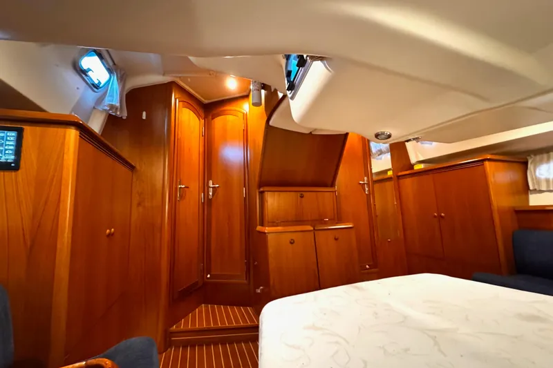  Yacht Photos Pics Interior of 2001 Jeanneau Sun Odyssey 43 DS, featuring elegant wooden cabinetry and cozy seating.