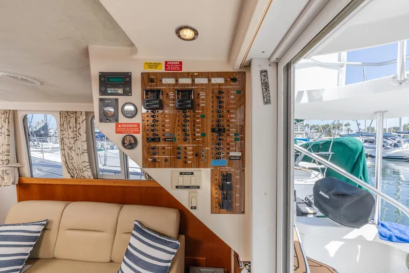 La Woman Yacht Photos Pics Interior of 2001 Mainship 390 Trawler showing control panel and seating area.