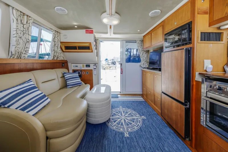 La Woman Yacht Photos Pics Interior of 2001 Mainship 390 Trawler with cozy seating and nautical decor.