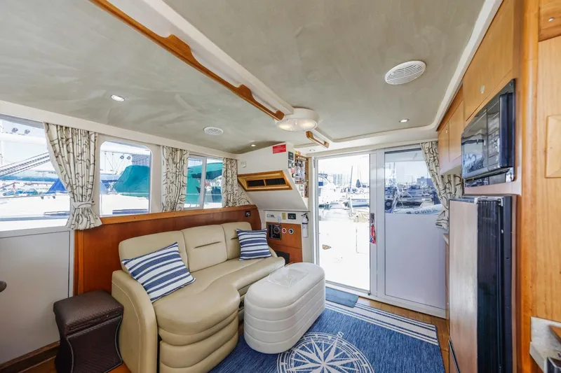 La Woman Yacht Photos Pics Interior of 2001 Mainship 390 Trawler with cozy seating and nautical decor.