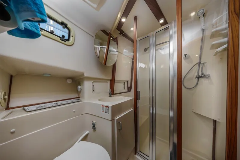 La Woman Yacht Photos Pics Bathroom of 2001 Mainship 390 Trawler with shower, sink, and mirror.