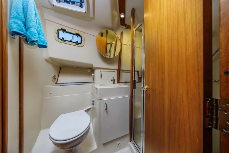 La Woman Yacht Photos Pics Bathroom interior of 2001 Mainship 390 Trawler with toilet, sink, and shower.