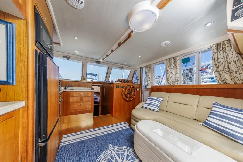 La Woman Yacht Photos Pics Interior of 2001 Mainship 390 Trawler with cozy seating and nautical decor.