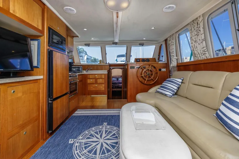 La Woman Yacht Photos Pics Interior of 2001 Mainship 390 Trawler with cozy seating and nautical decor.