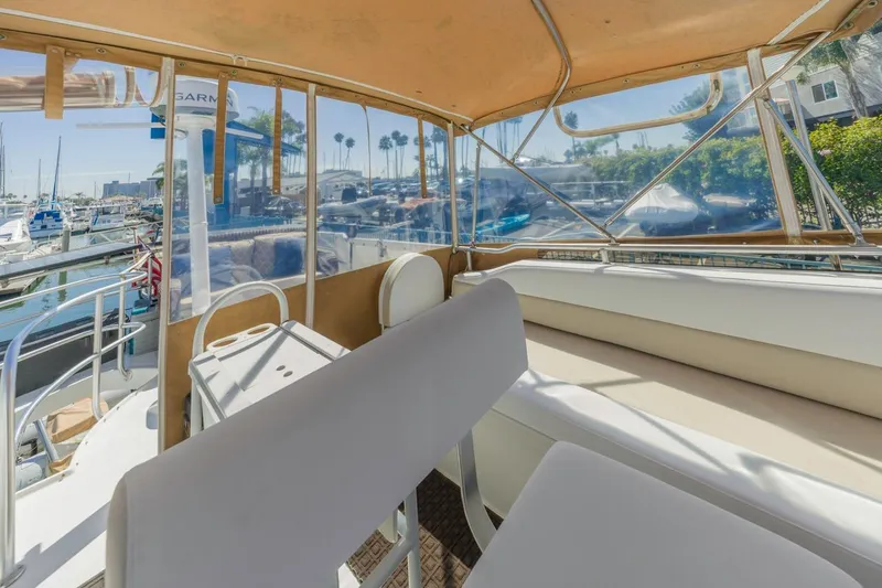 La Woman Yacht Photos Pics 2001 Mainship 390 Trawler interior with seating, marina view, and clear canopy.
