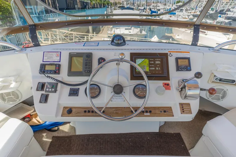 La Woman Yacht Photos Pics Helm of 2001 Mainship 390 Trawler with navigation instruments and steering wheel.