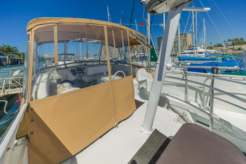 La Woman Yacht Photos Pics 2001 Mainship 390 Trawler docked at marina, featuring spacious deck and helm enclosure.