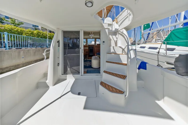 La Woman Yacht Photos Pics 2001 Mainship 390 Trawler boat deck with stairs and sliding door.