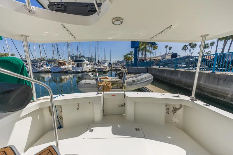 La Woman Yacht Photos Pics 2001 Mainship 390 Trawler docked at marina with surrounding boats and clear sky.