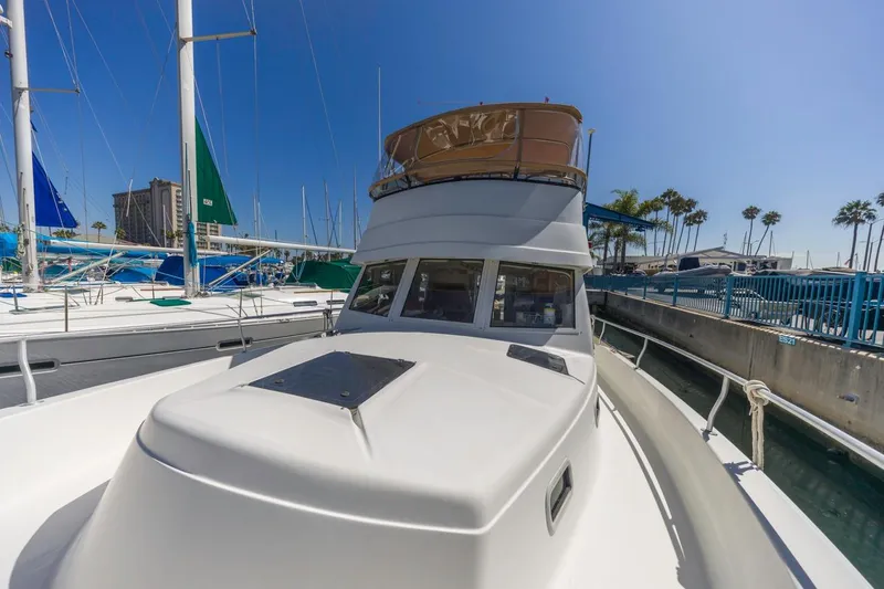 La Woman Yacht Photos Pics 2001 Mainship 390 Trawler docked at marina under clear blue sky.