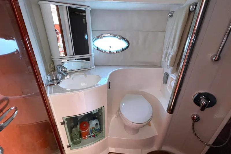 Pearl Yacht Photos Pics Bathroom interior of 2004 Fairline Targa 40 yacht, featuring sink, toilet, and porthole window.