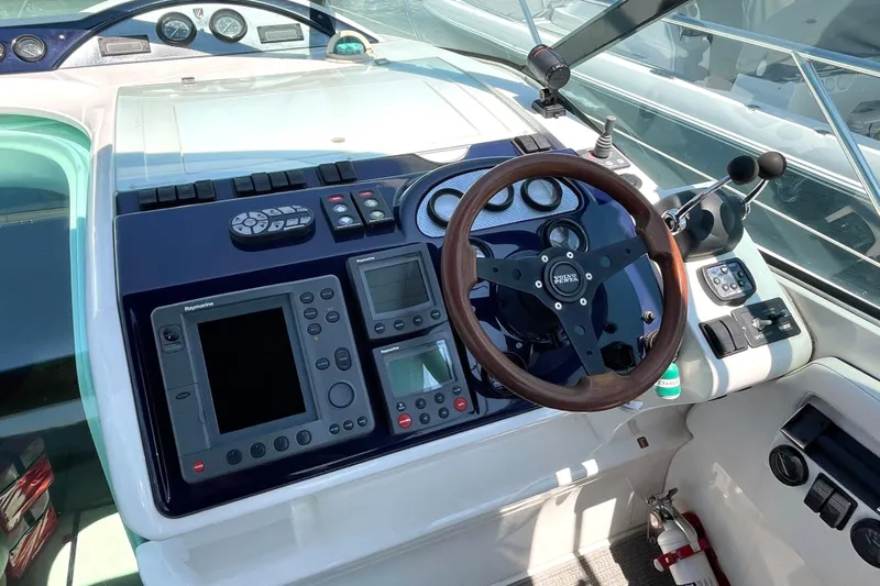 Pearl Yacht Photos Pics 2004 Fairline Targa 40 yacht dashboard with steering wheel and navigation controls.