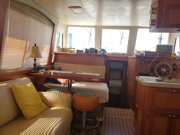 Angels Only Yacht Photos Pics Interior of 2007 Mainship 400 Trawler with cozy seating and wooden accents.