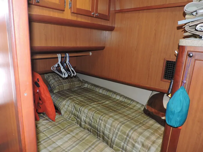 Angels Only Yacht Photos Pics 2007 Mainship 400 Trawler cabin with plaid bedding and wooden cabinetry.