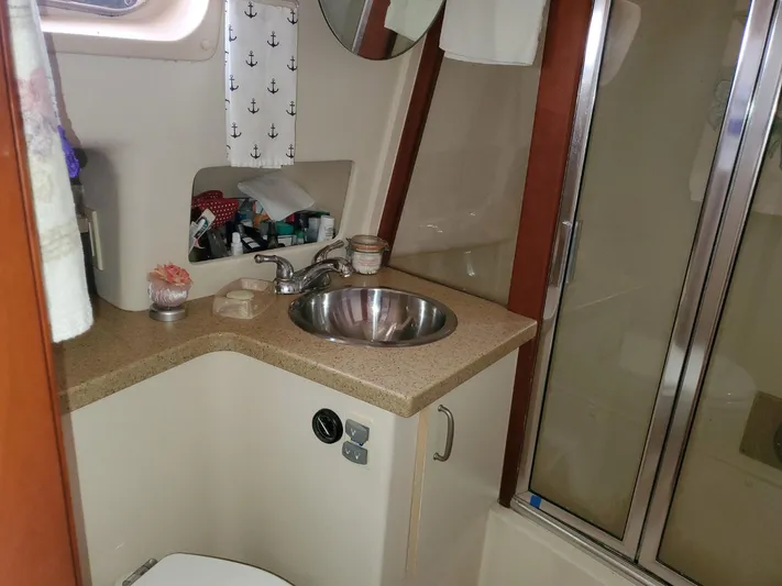 Angels Only Yacht Photos Pics Bathroom interior of 2007 Mainship 400 Trawler with sink, mirror, and shower.