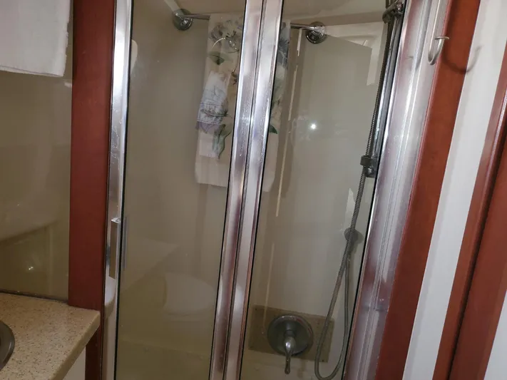 Angels Only Yacht Photos Pics Shower area in 2007 Mainship 400 Trawler with glass doors and modern fixtures.