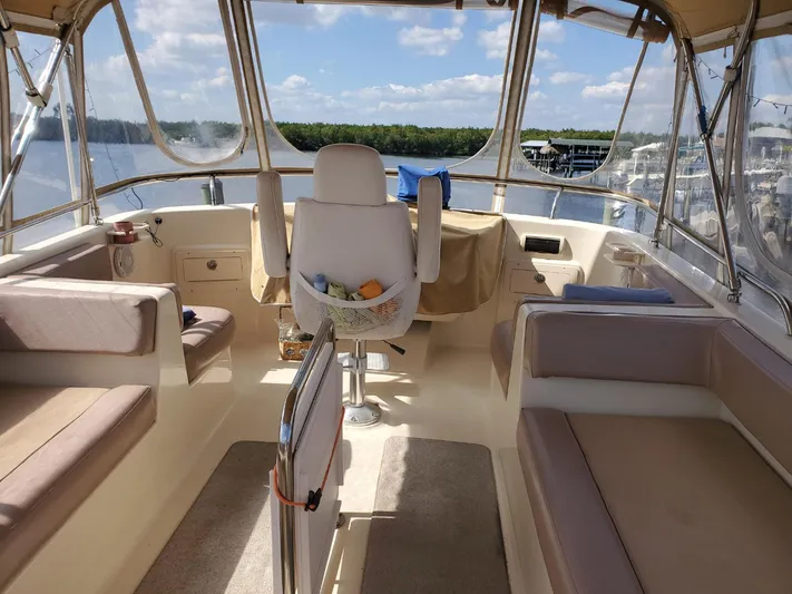 Angels Only Yacht Photos Pics 2007 Mainship 400 Trawler interior with seating and helm, overlooking a scenic water view.