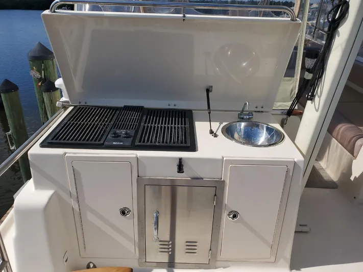 Angels Only Yacht Photos Pics Outdoor kitchen on a 2007 Mainship 400 Trawler with grill and sink.