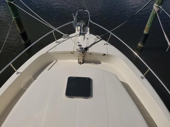 Angels Only Yacht Photos Pics 2007 Mainship 400 Trawler bow view with anchor and railing, docked on calm water.