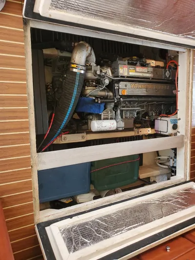 Angels Only Yacht Photos Pics Engine compartment of a 2007 Mainship 400 Trawler, showcasing mechanical components and storage.