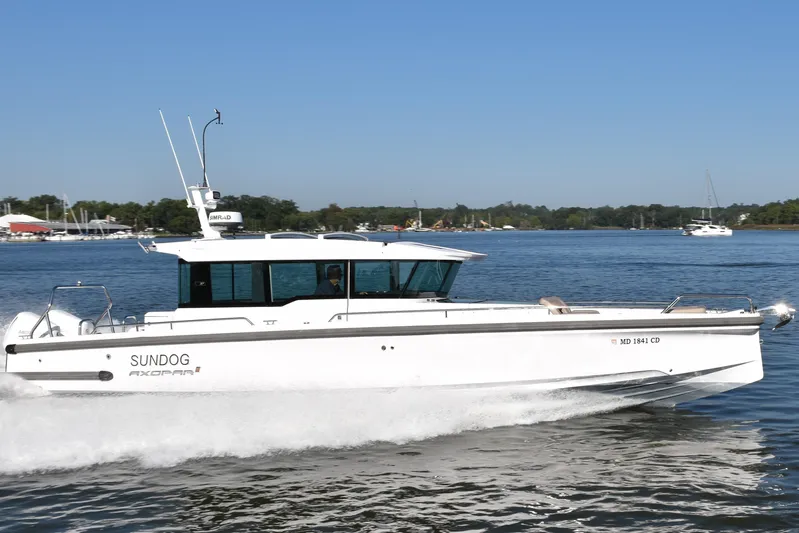 Sundog Yacht Photos Pics 2023 Axopar 37XC Wet Bar boat cruising on a sunny day.