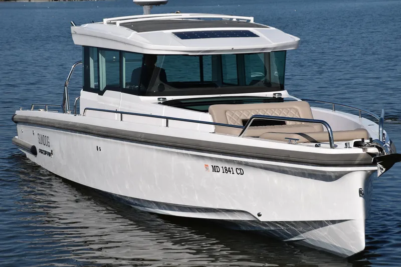 Sundog Yacht Photos Pics 2023 Axopar 37XC Wet Bar boat on calm water, featuring sleek design and modern amenities.