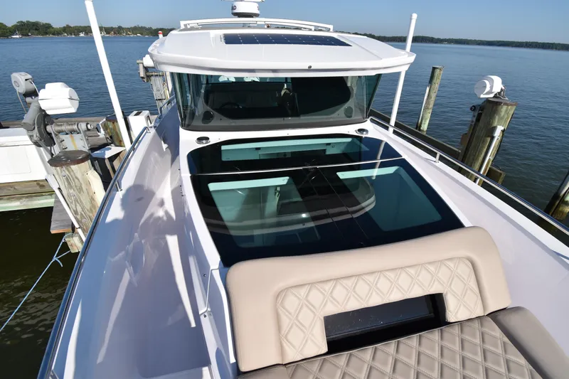 Sundog Yacht Photos Pics 2023 Axopar 37XC Wet Bar boat docked, featuring sleek design and spacious deck.