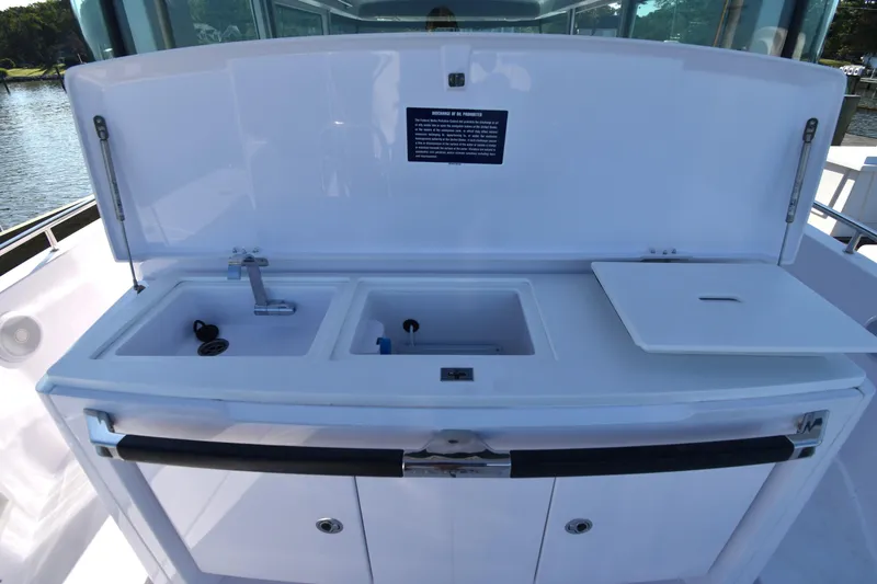 Sundog Yacht Photos Pics 2023 Axopar 37XC Wet Bar with sink and storage compartments on deck.