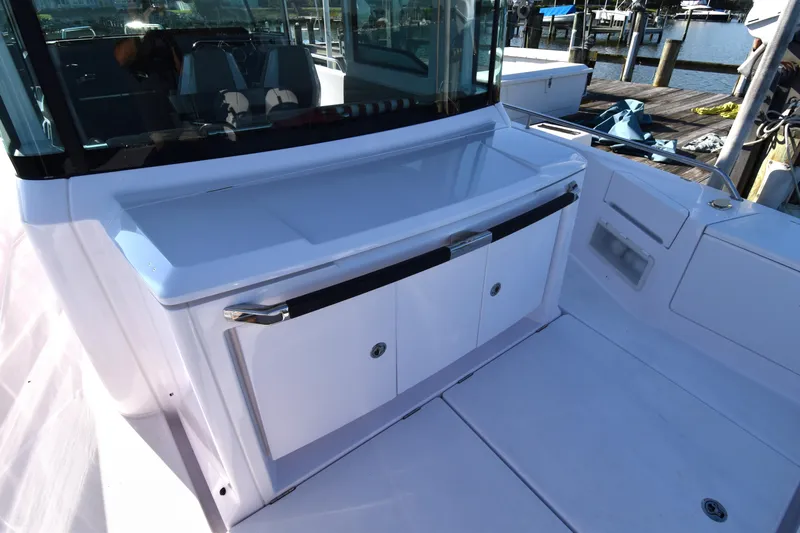 Sundog Yacht Photos Pics 2023 Axopar 37XC Wet Bar, sleek design, docked at marina.