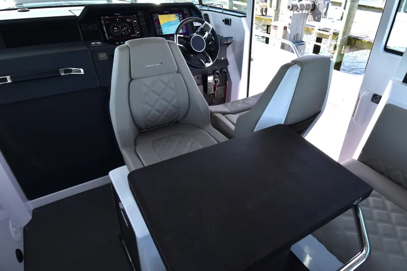 Sundog Yacht Photos Pics 2023 Axopar 37XC Wet Bar interior with modern seating and navigation controls.