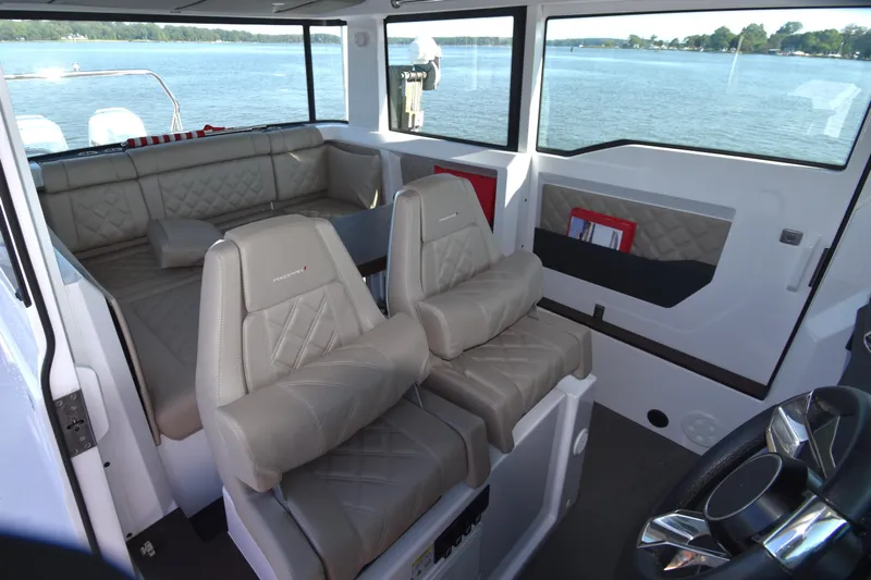 Sundog Yacht Photos Pics 2023 Axopar 37XC Wet Bar interior with luxurious seating and panoramic windows.