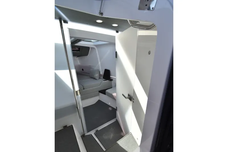 Sundog Yacht Photos Pics Interior cabin of 2023 Axopar 37XC Wet Bar, featuring modern seating and sleek design.