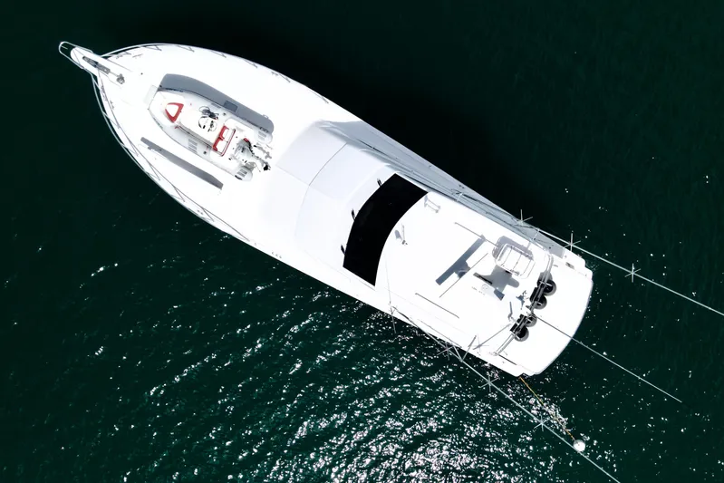 Red Queen Yacht Photos Pics Aerial view of 2008 Hatteras 64 Convertible yacht on dark water.