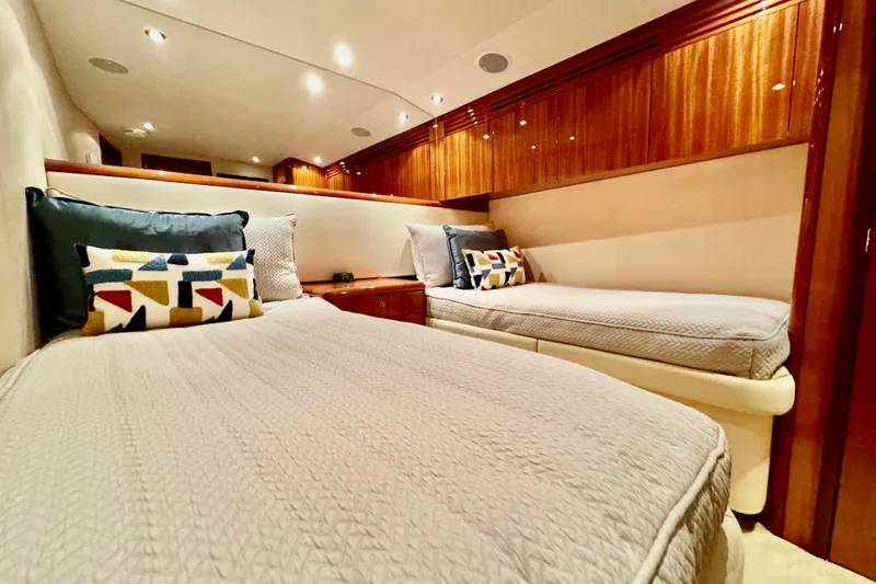 Red Queen Yacht Photos Pics Luxurious cabin interior of 2008 Hatteras 64 Convertible yacht with twin beds and elegant wood finish.
