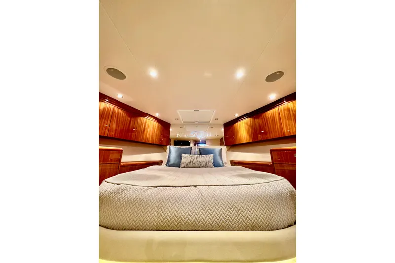 Red Queen Yacht Photos Pics Luxurious bedroom interior of 2008 Hatteras 64 Convertible yacht with elegant wood cabinetry.