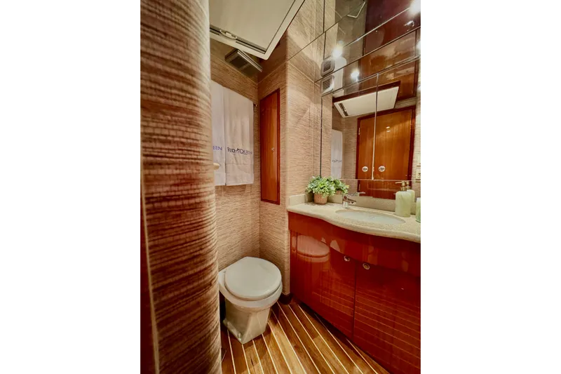 Red Queen Yacht Photos Pics Luxurious bathroom in 2008 Hatteras 64 Convertible yacht with elegant wood finishes.