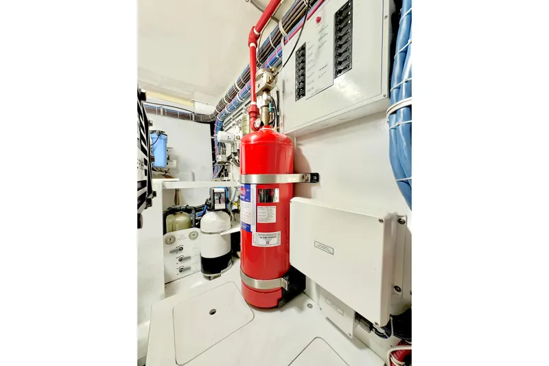 Red Queen Yacht Photos Pics Engine room of 2008 Hatteras 64 Convertible with fire extinguisher and control panels.