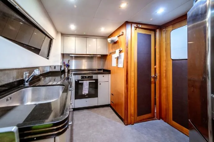  Yacht Photos Pics Luxurious kitchen interior of 2009 Sunseeker 90 yacht with modern appliances and sleek design.