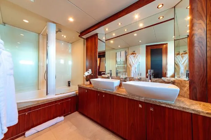  Yacht Photos Pics Luxurious bathroom in a 2009 Sunseeker 90 yacht with dual sinks and elegant wood finishes.