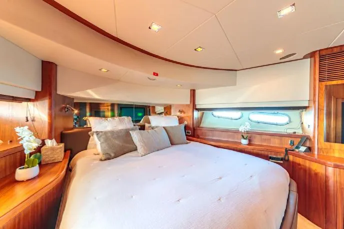  Yacht Photos Pics Luxurious Sunseeker 90 yacht bedroom interior, 2009 model, featuring elegant wood finishes and plush bedding.