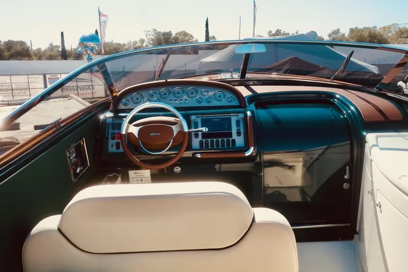  Yacht Photos Pics Interior view of a 2003 Riva Aquariva 33 boat, featuring a classic wooden dashboard and steering wheel.