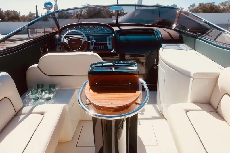  Yacht Photos Pics Luxurious interior of a 2003 Riva Aquariva 33 yacht with elegant seating and dashboard.
