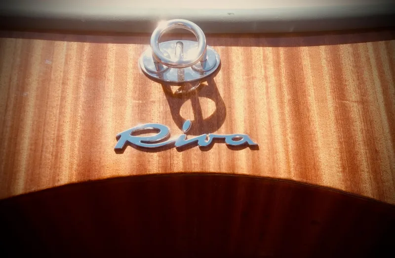  Yacht Photos Pics Riva Aquariva 33 boat emblem on polished wooden surface, 2003 model.