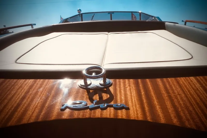  Yacht Photos Pics 2003 Riva Aquariva 33 boat with polished wood deck and logo in sunlight.